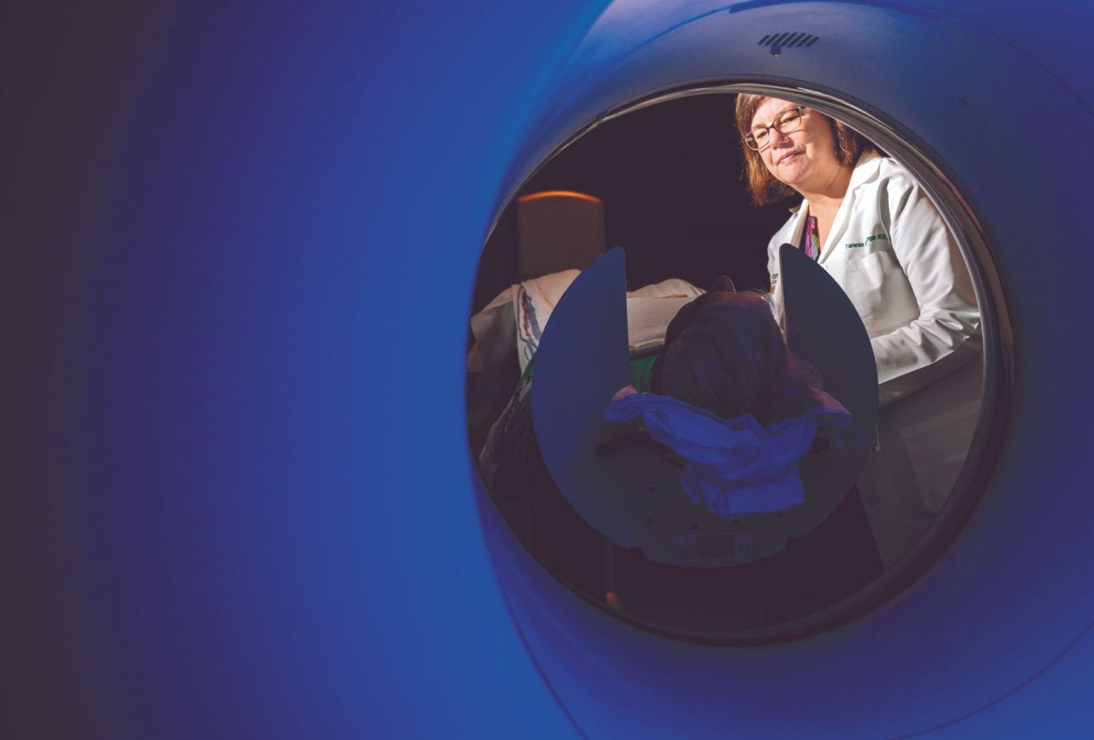 healthcare worker helping a person prepare for MRI