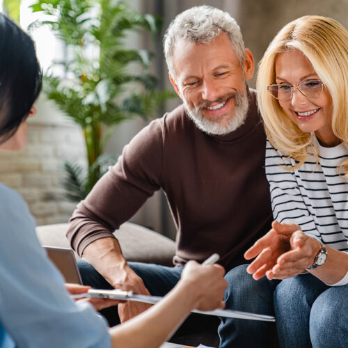 an elderly couple listen to advice from an estate planner