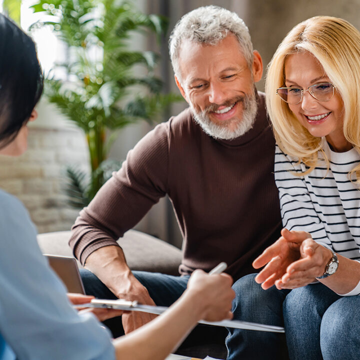 an elderly couple listen to advice from an estate planner