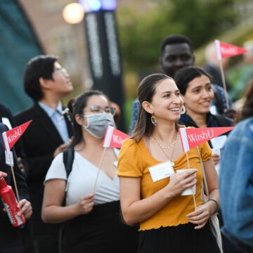 Students waving pennants at the launch of Make Way: Our Student Initiative